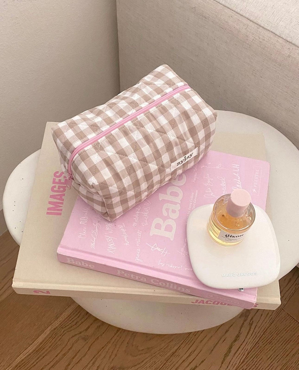 Brown-and-cream gingham pouch with pink zip and small label patch on front