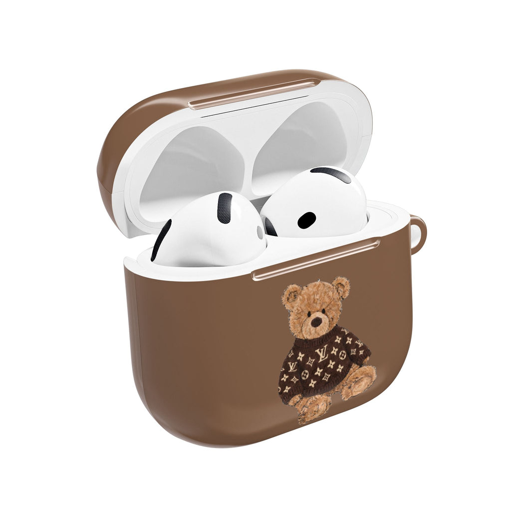 Brown earbud case with open lid; white earbuds and teddy bear patch sweater