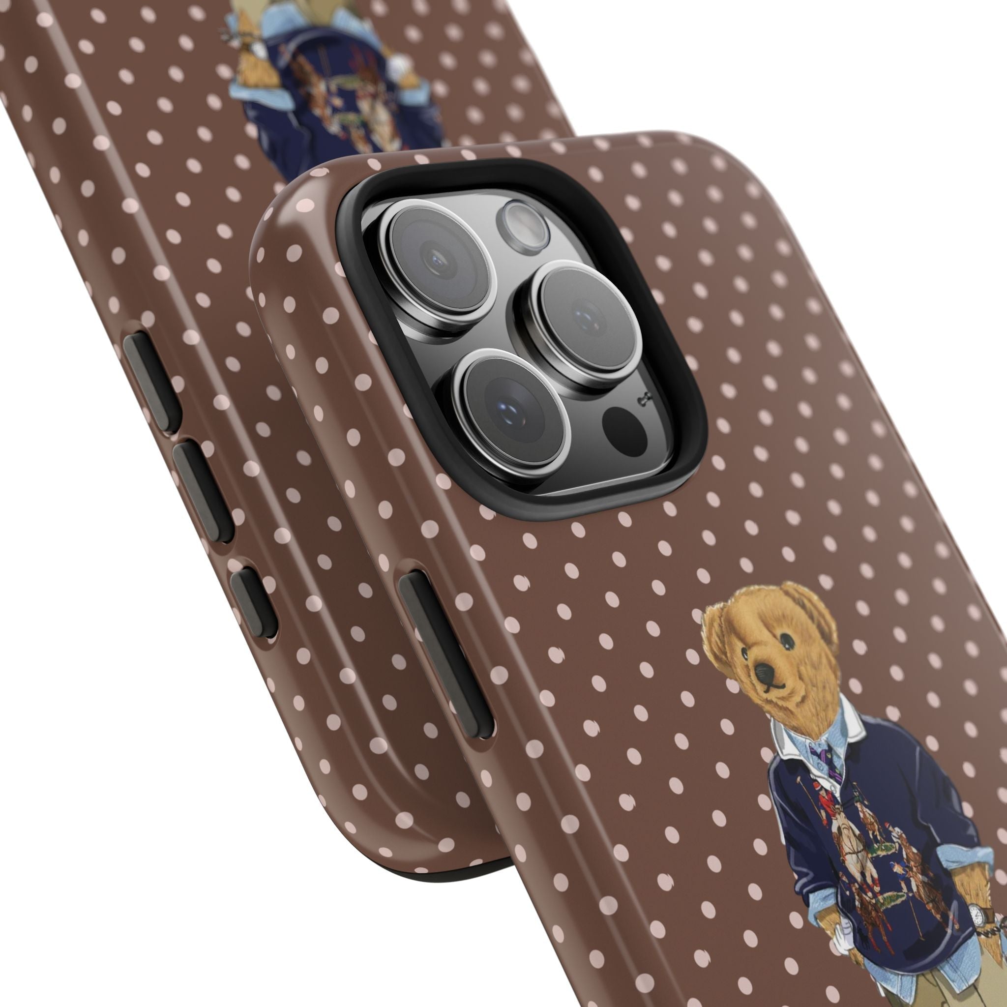 Brown polka-dot phone case with teddy bear graphic; raised camera edges and side buttons
