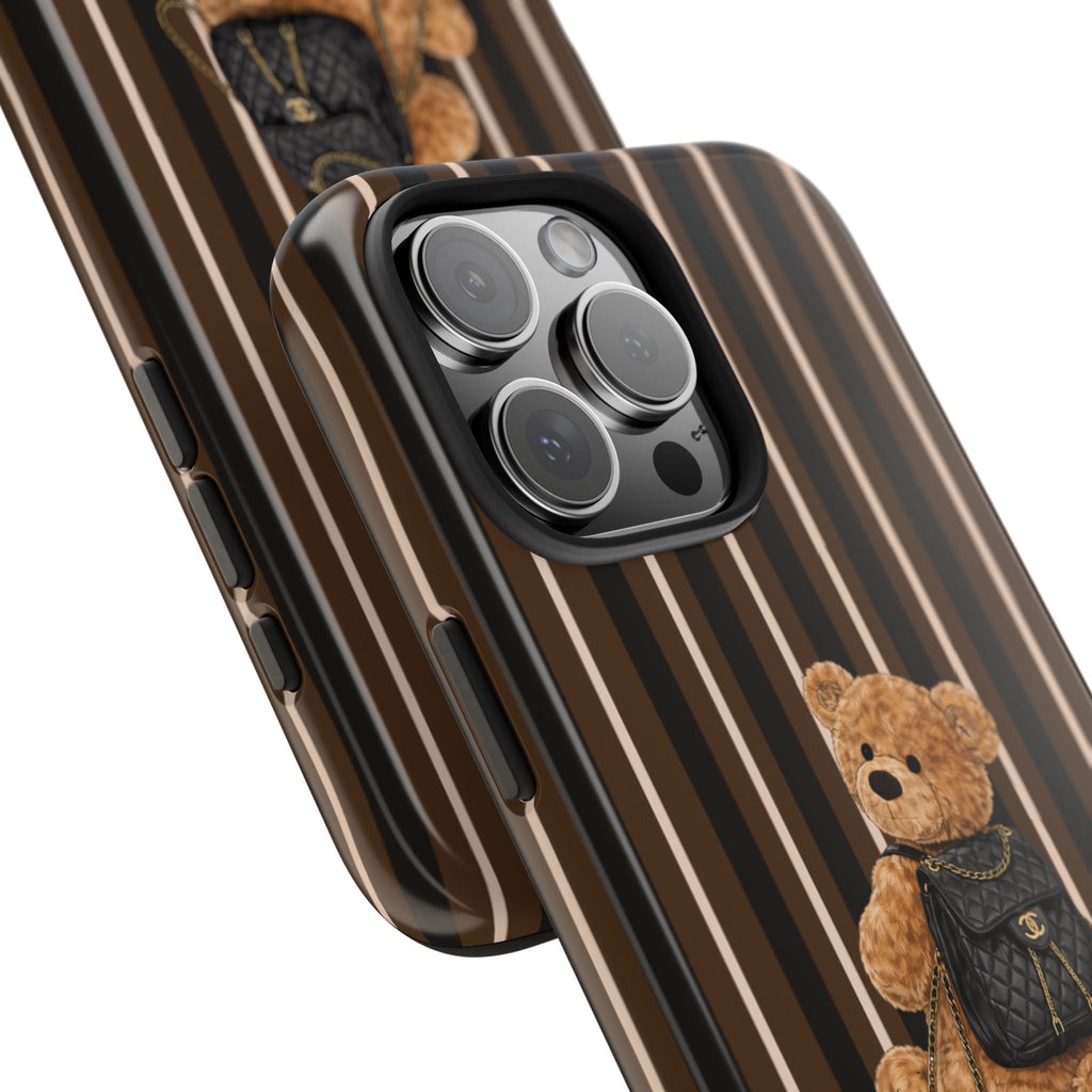 Brown striped phone case angled view with teddy bear backpack near camera cutouts