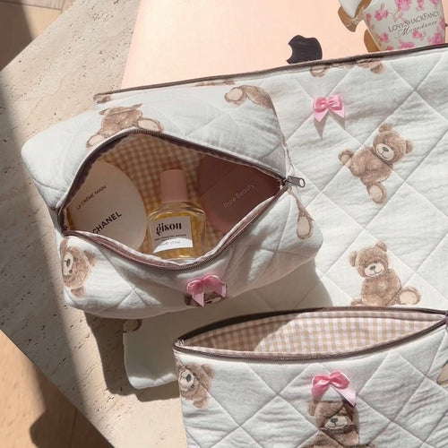 Open quilted white teddy zip pouch with brown plaid lining and pink bow
