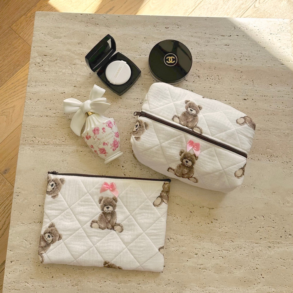 Quilted white zip pouches with brown teddy bear print and pink bow accents
