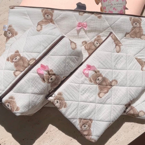 Pair of quilted white teddy bear pouches with pink bow zipper pulls