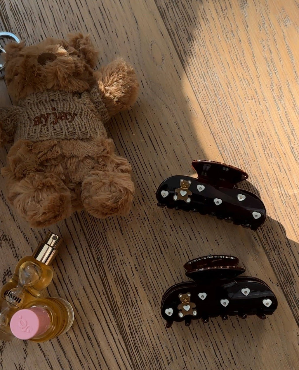 Set of dark brown hair claw clips with teddy bear and heart rhinestone details