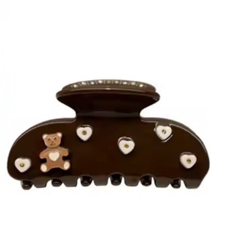 Dark brown hair claw clip with teddy bear and heart rhinestone details, front view