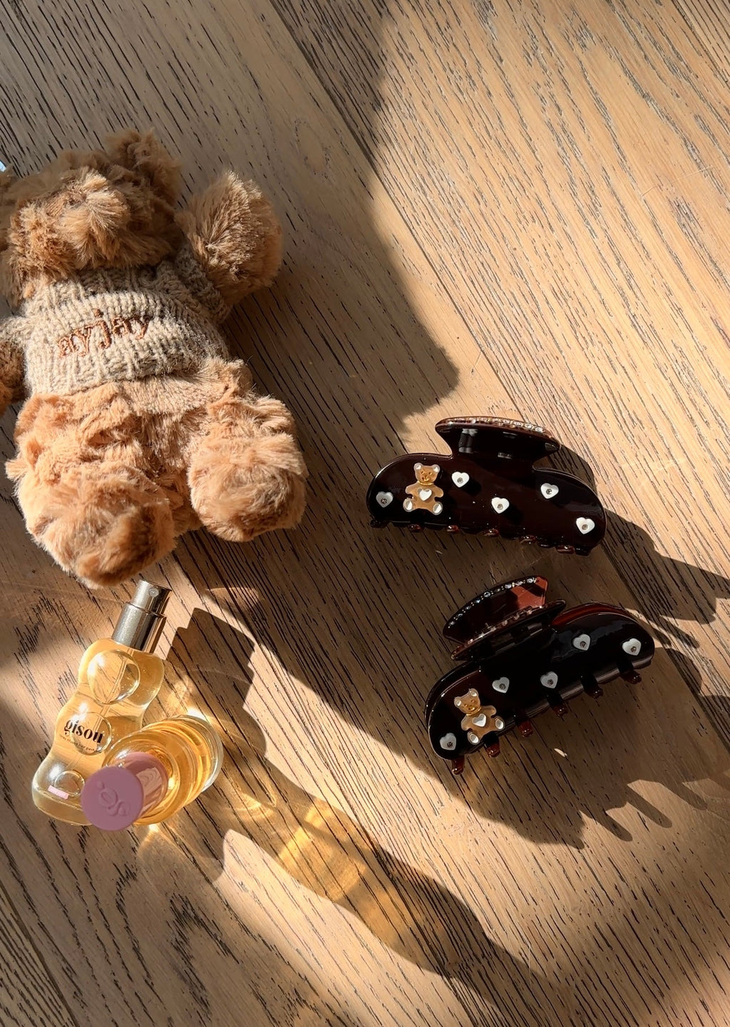 Brown hair claw clip with teddy bear and heart rhinestone details, glossy finish