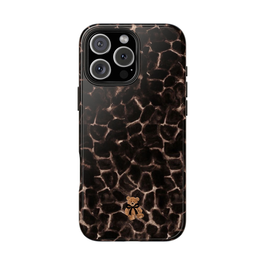 Brown tortoise shell teddy bear phone case with bear charm near bottom center, glossy look
