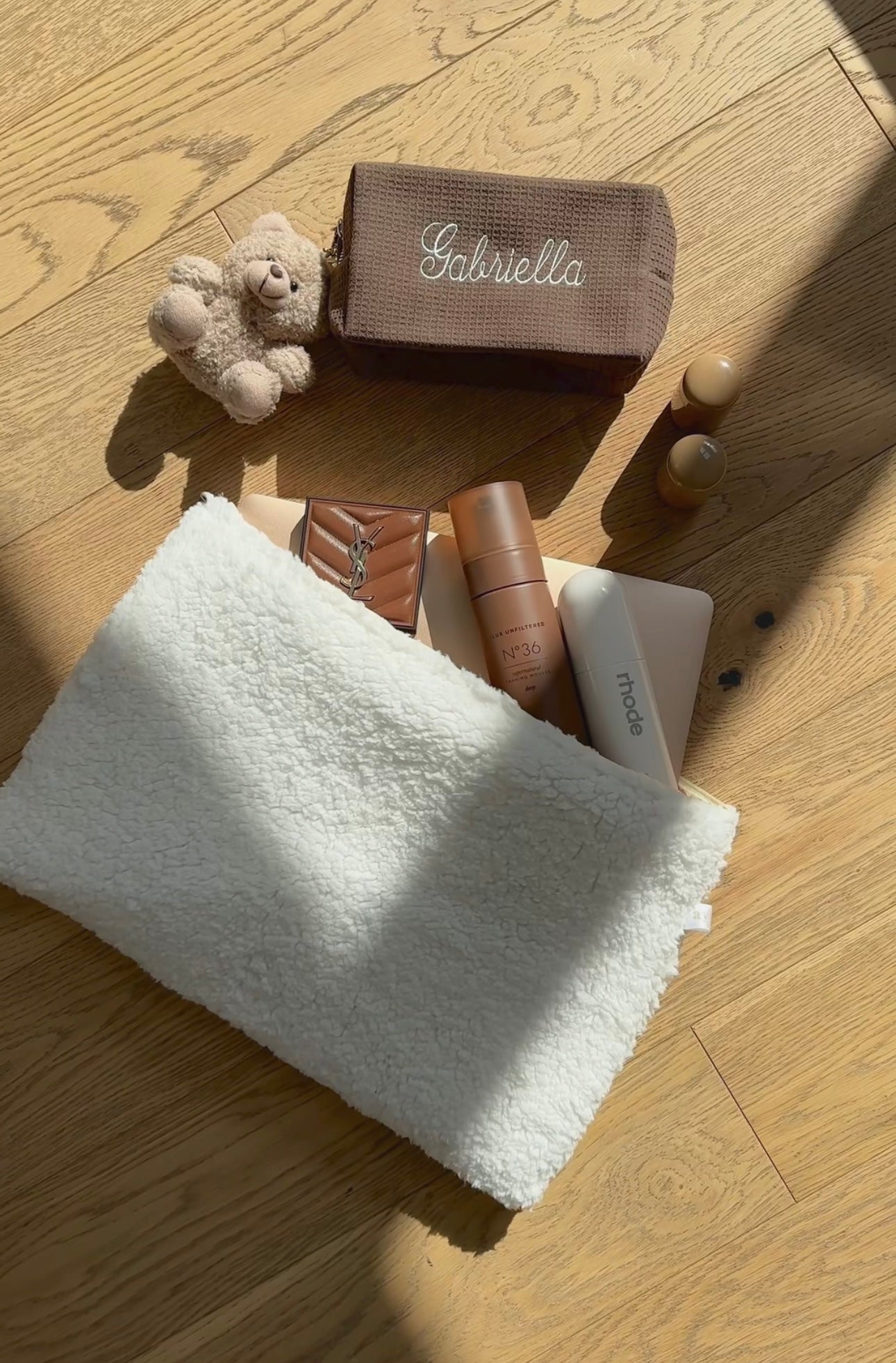 Brown waffle-knit custom embroidery pouch with white script on the front