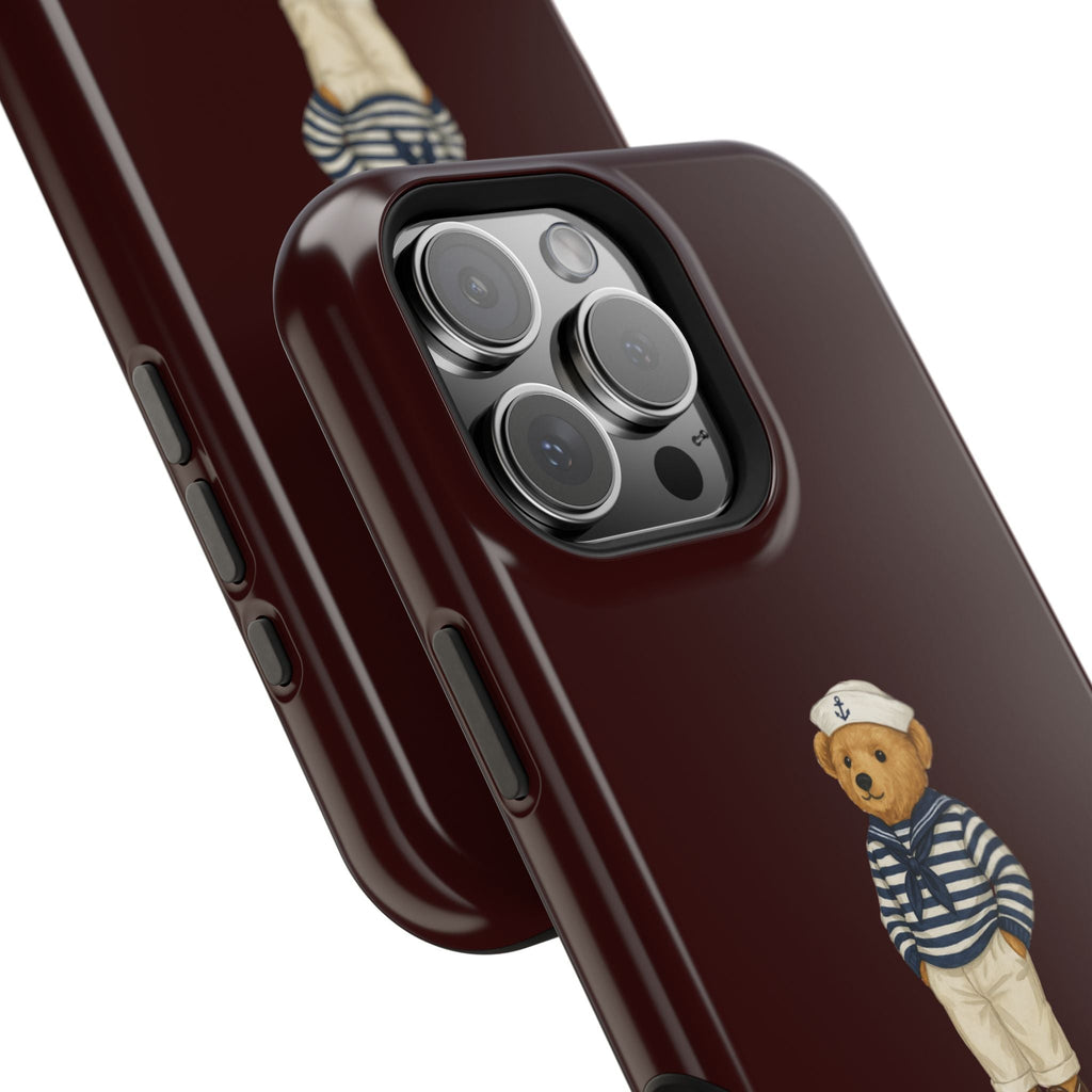 Close-up burgundy phone case with sailor teddy bear patch and side button cutouts