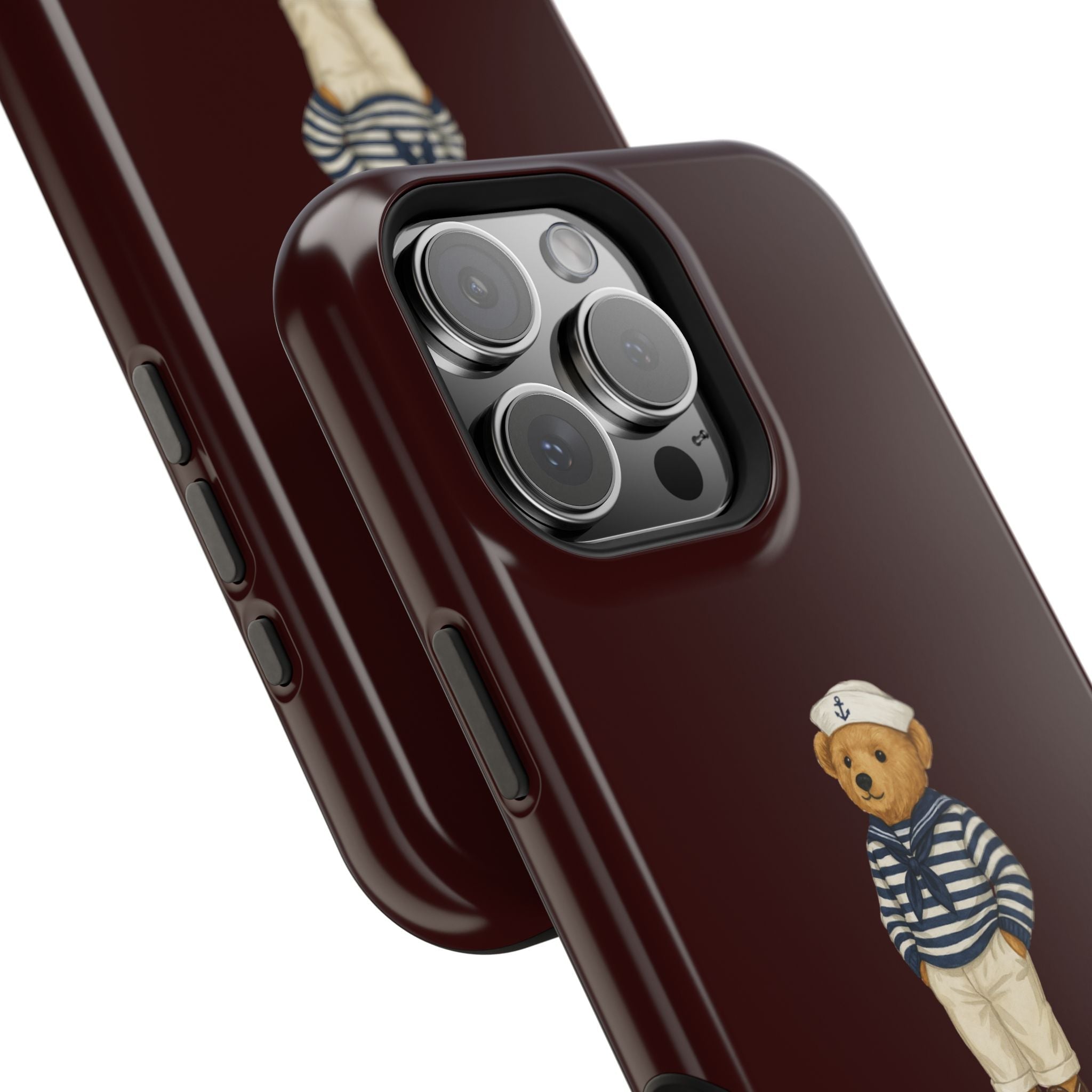 Close-up burgundy phone case with sailor teddy bear patch and side button cutouts