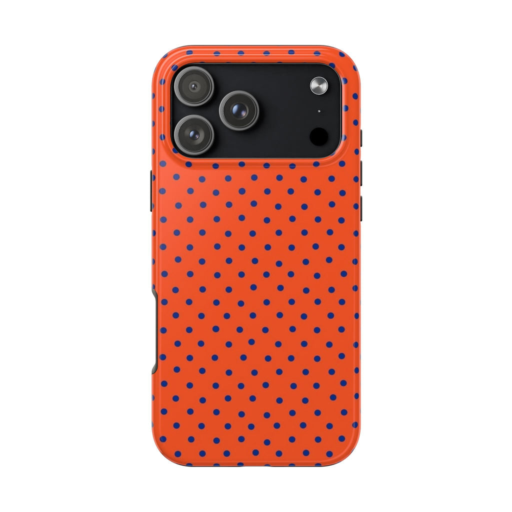 Burnt orange phone case with navy mini polka dots; camera opening on dark panel