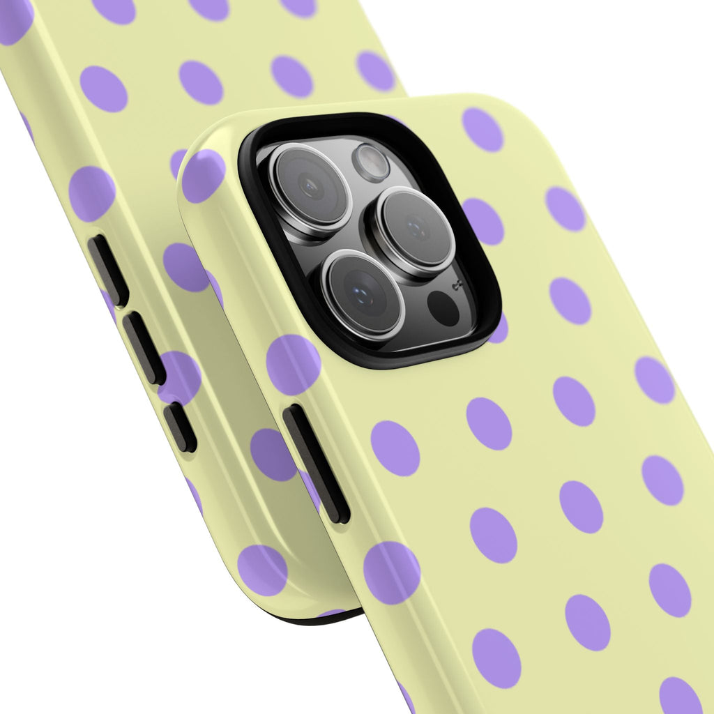 Close-up butter yellow phone case with purple polka dots and raised camera lens cover
