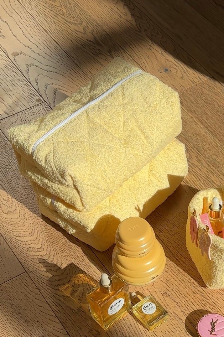 Butter yellow terrycloth zip pouch with scalloped edges and white zipper trim