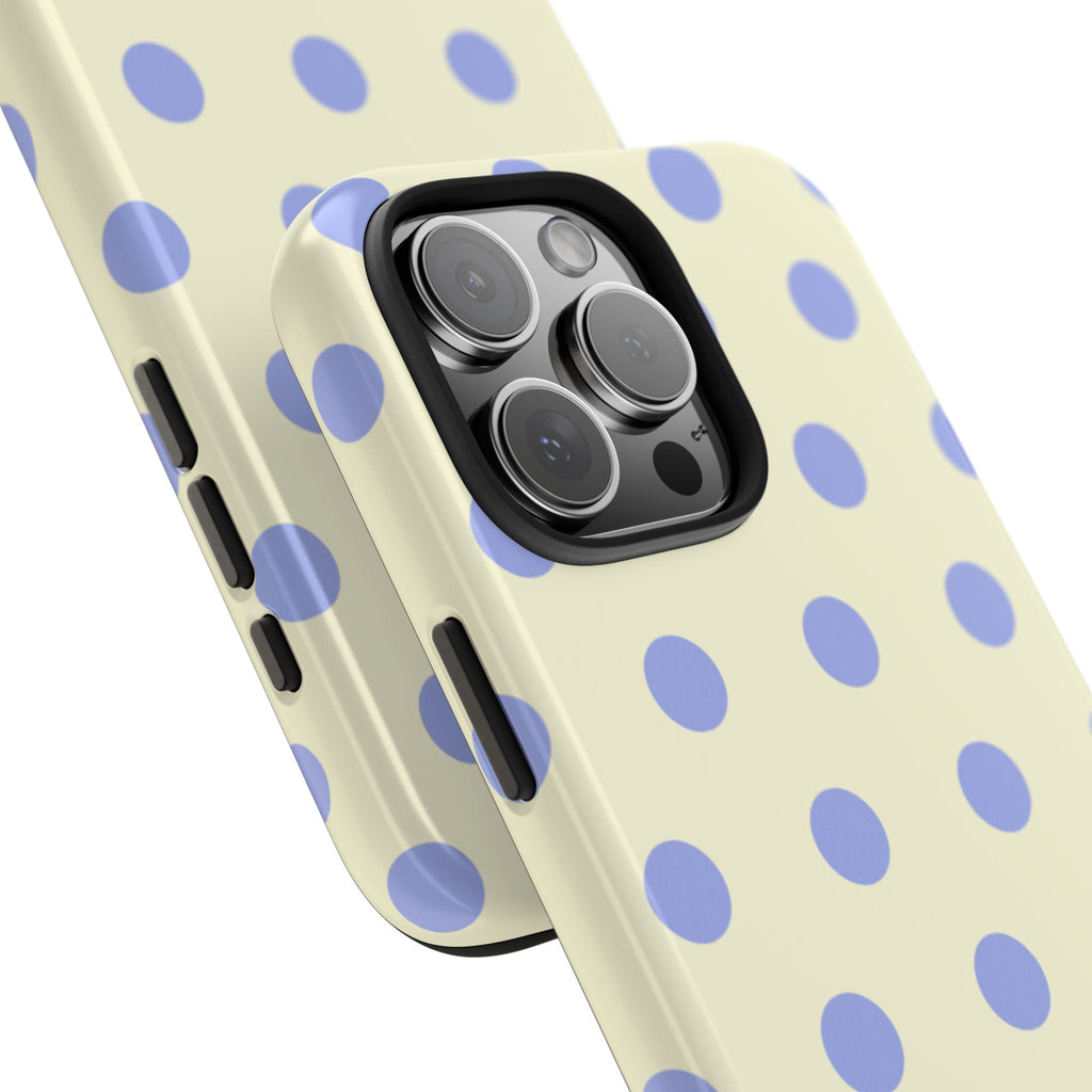 Cream polka dot phone case at angle showing side buttons and camera lenses