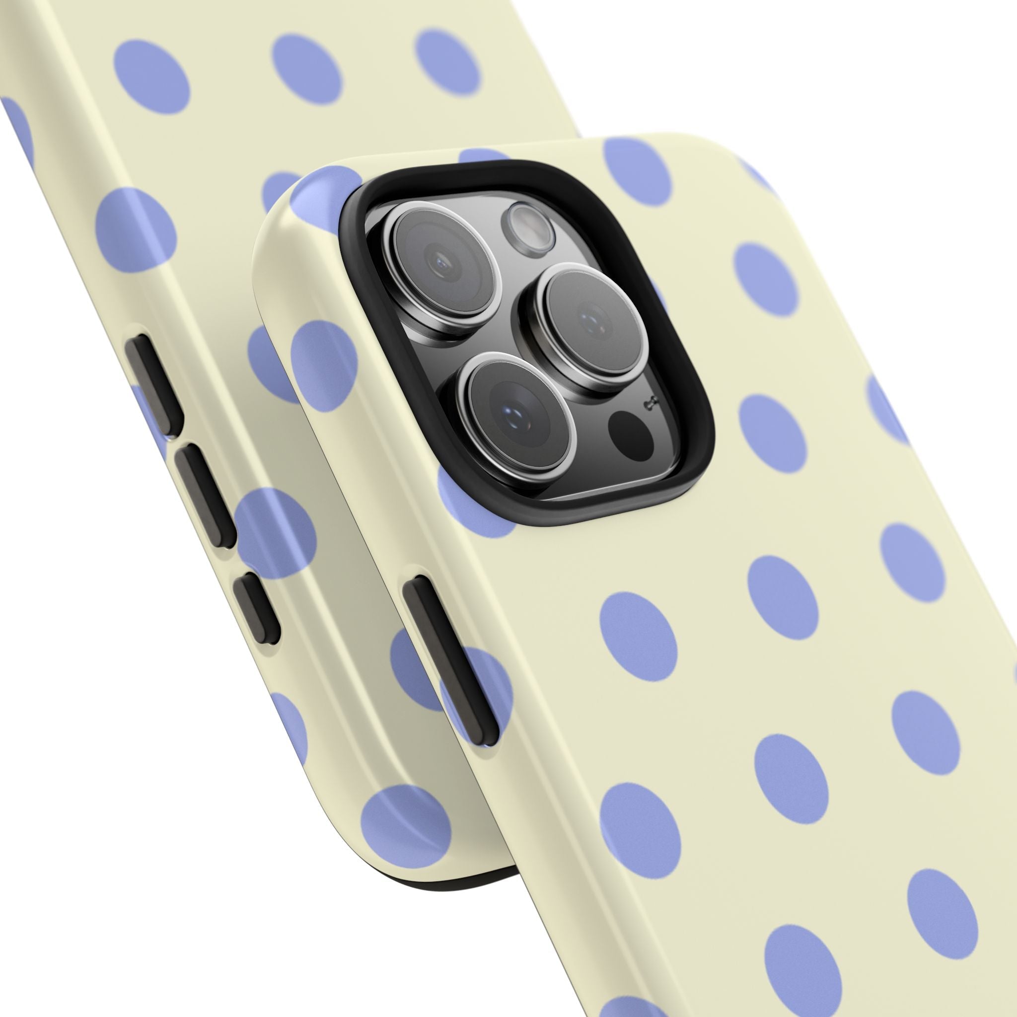 Cream polka dot phone case at angle showing side buttons and camera lenses
