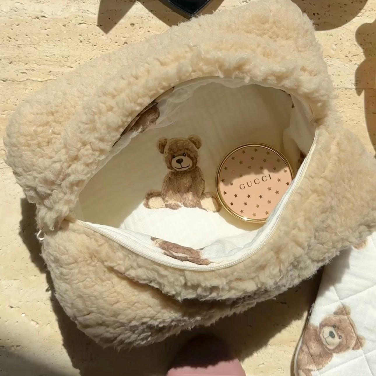 Camel teddy bear sherpa pouch with zipper opening and bear face print on lining