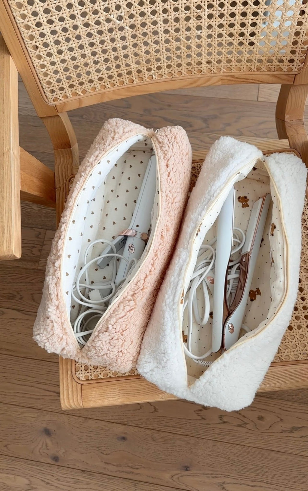 Two plush teddy pouches with zip openings, cream outer and blush inner lining
