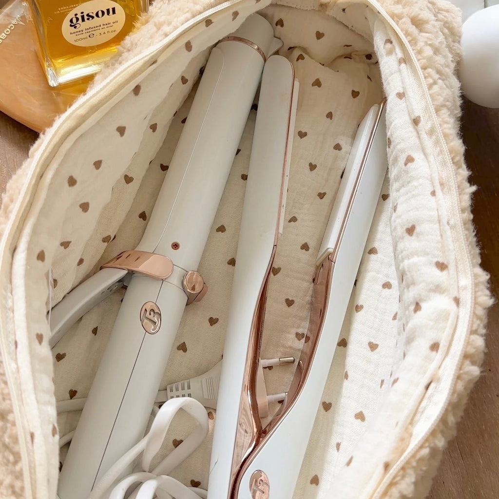 Heart-pattern fabric lining inside a soft teddy pouch, showing organizer compartments