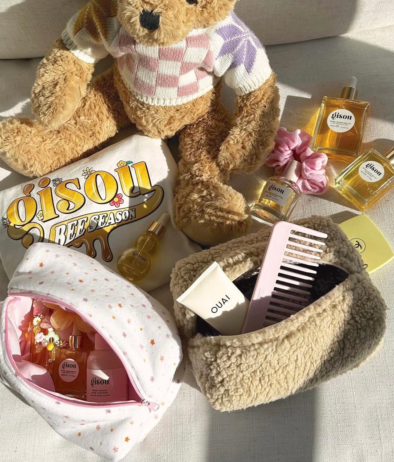 Camel teddy round zip pouch open with plush bear and bottles; sherpa texture visible.