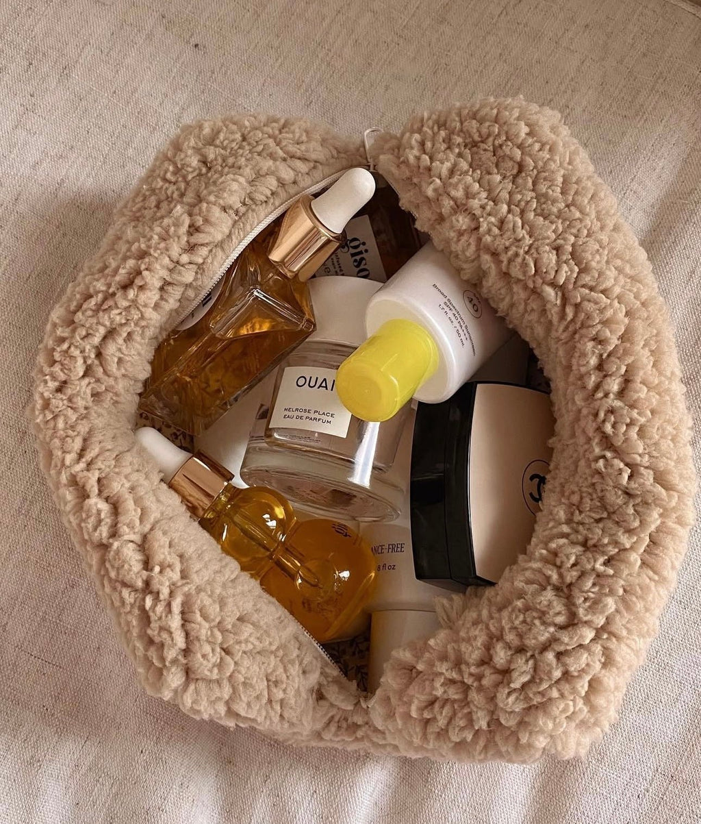 Camel soft teddy round zip pouch, partially open with thick sherpa texture and zipper.