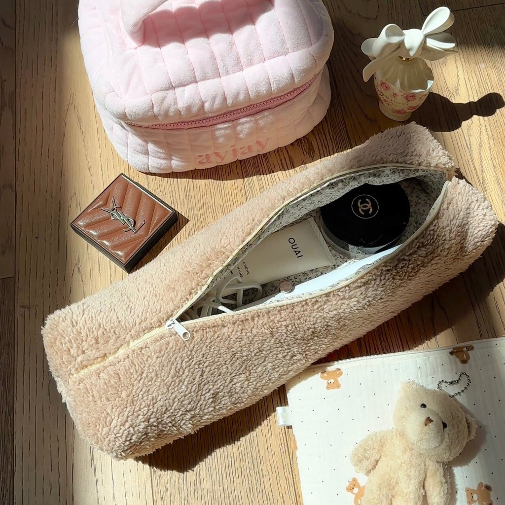 Camel soft teddy long zip pouch lying open, showing inner fabric and zipper tape.
