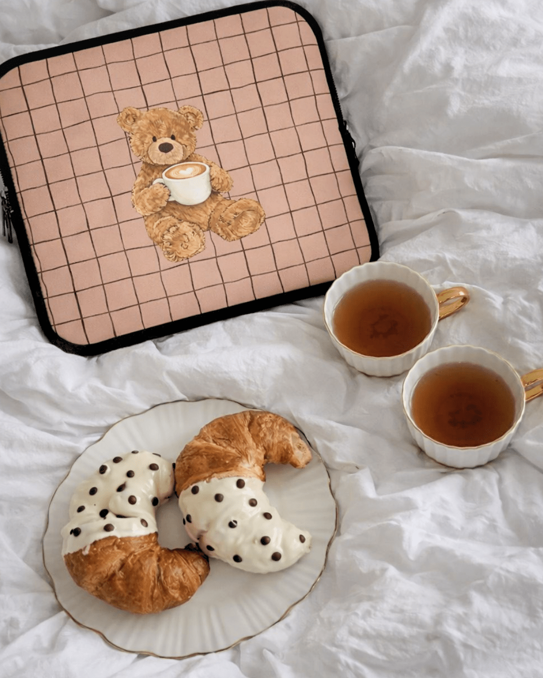 Cappuccino teddy bear neoprene sleeve with bear holding a latte cup on a grid