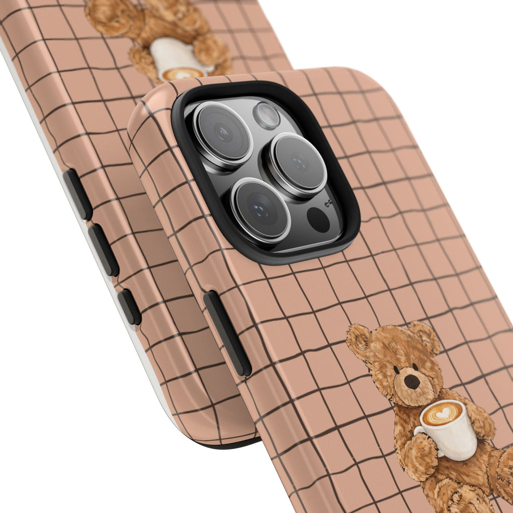 Angled teddy bear phone case with beige grid, side button cutout and latte cup charm
