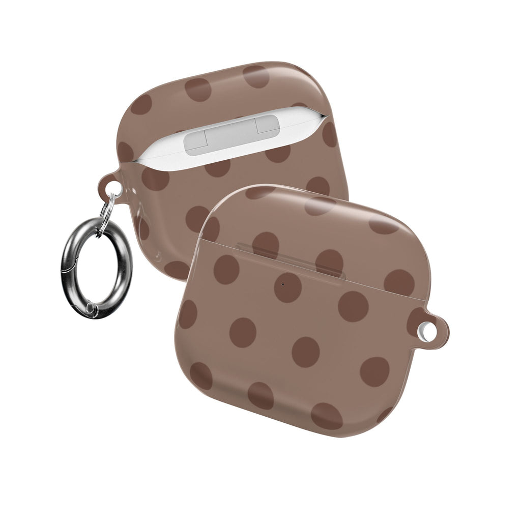 Two chocolate-brown AirPods cases with tan polka dots; one closed, one open with keyring