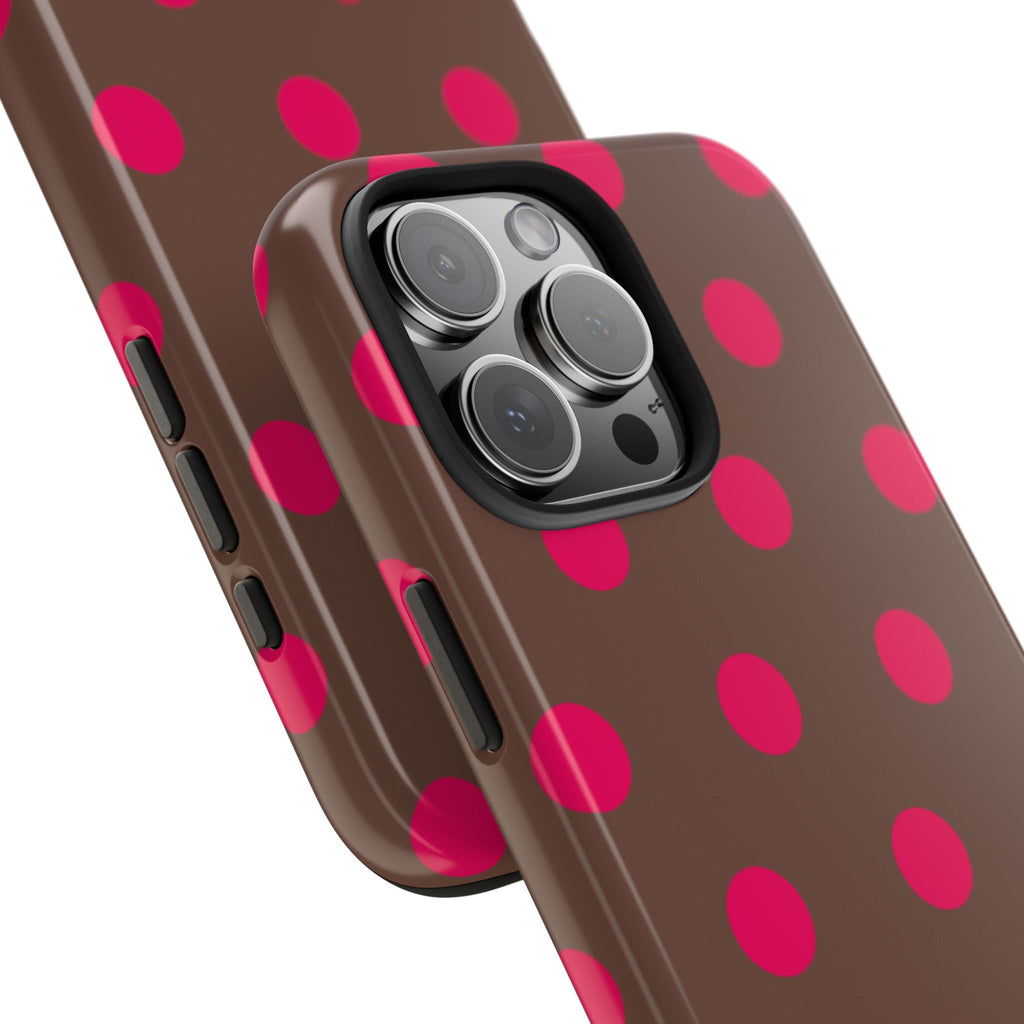 Side view of chocolate brown phone case with pink polka dots and button cutouts