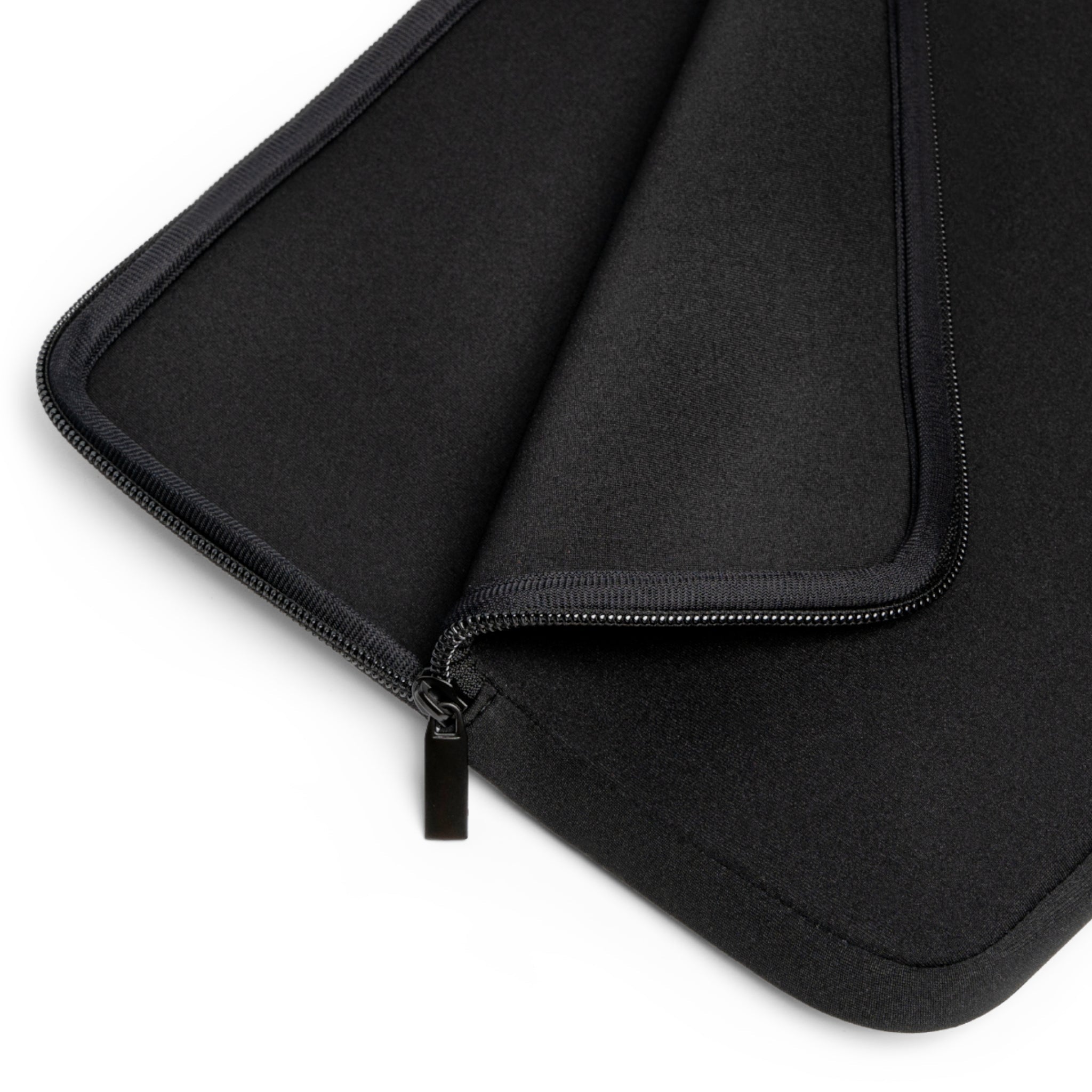 Angled view of black neoprene lining and zipper pull inside the sleeve.