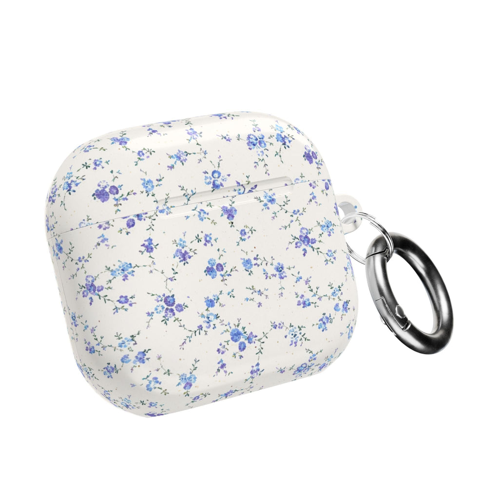 Blue ditsy floral AirPods case closed with metal key ring loop on side, white base