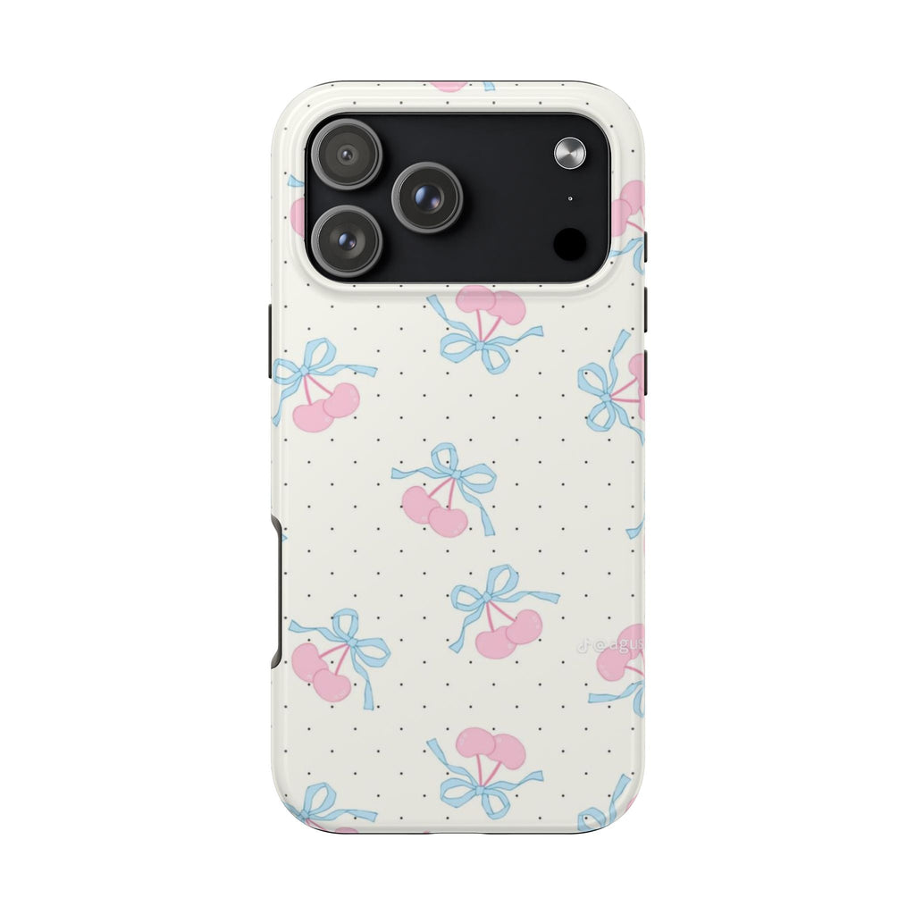 White phone case with pink cherries and blue bows over black polka dots; triple-lens cutout