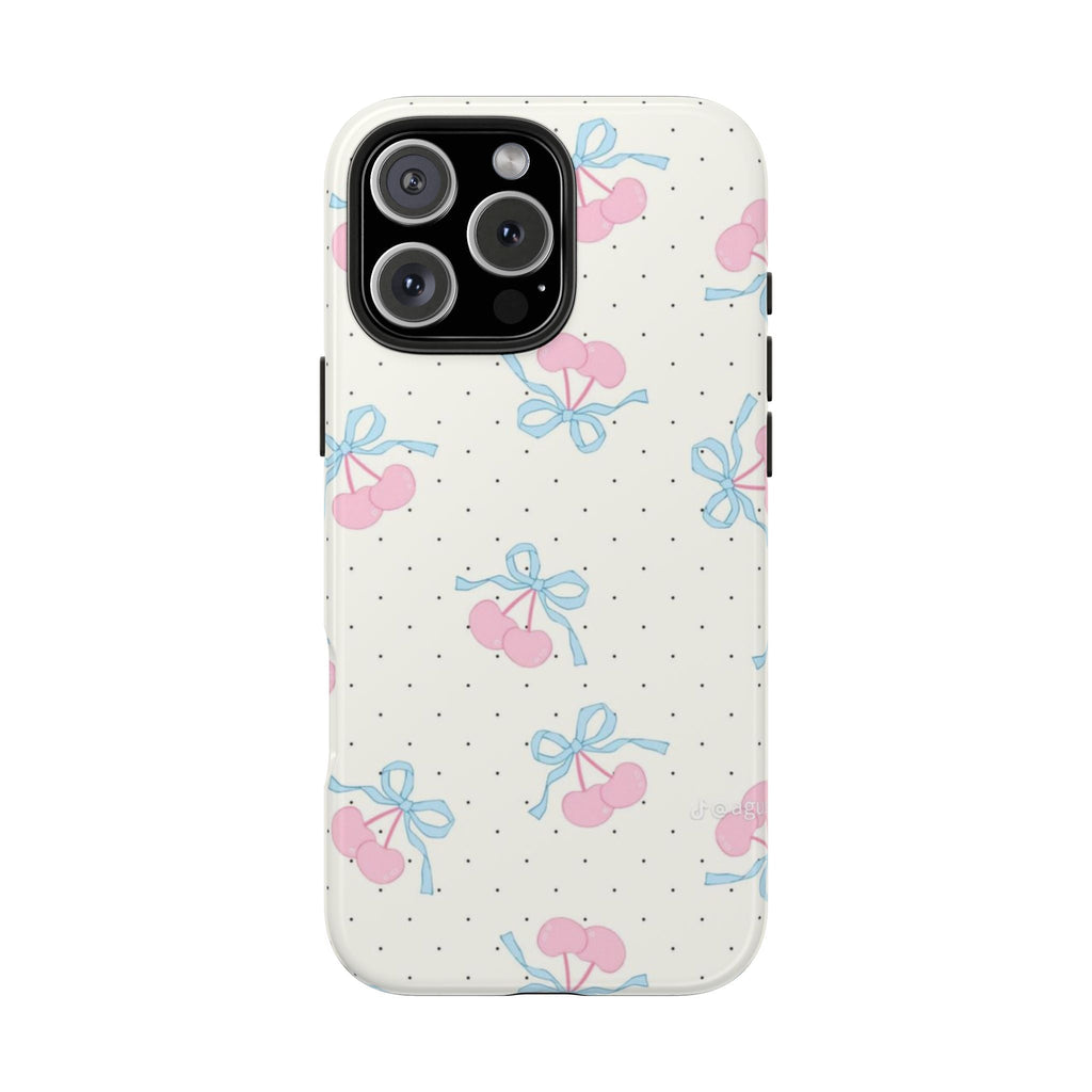 White phone case with pink cherry-and-blue-bow pattern and black polka dots, camera cutout