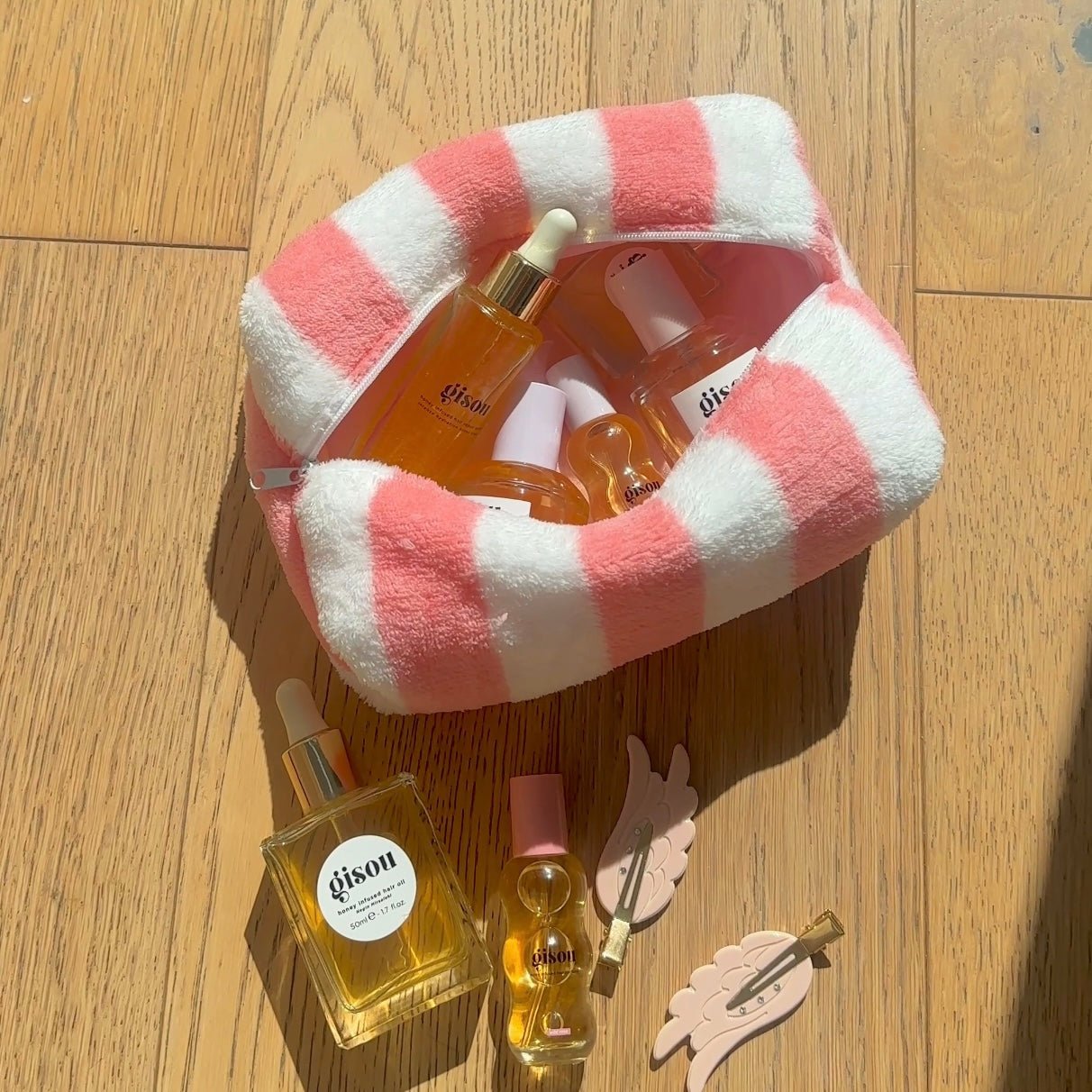 Coral and white candy-cane striped plush zip pouch, open top
