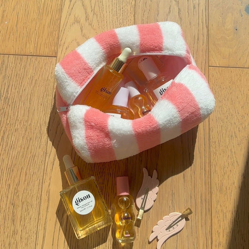 Coral and white candy-cane striped plush zip pouch, open top
