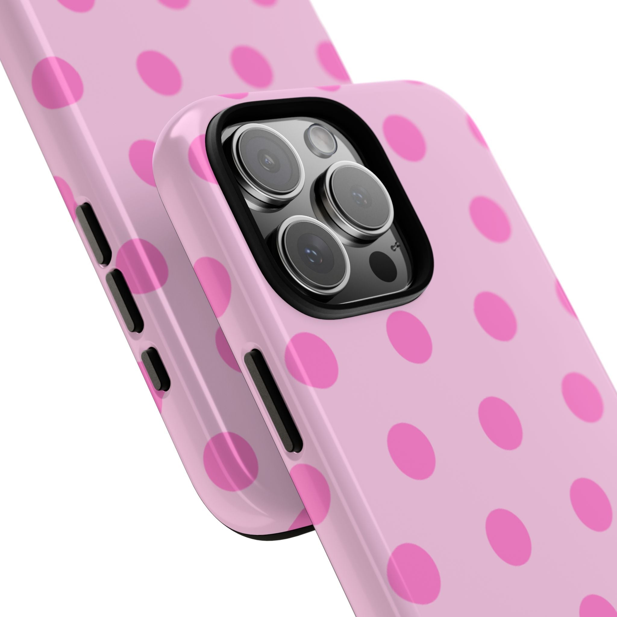 Angled view of pink polka dot phone case showing lens cover and side button cutouts