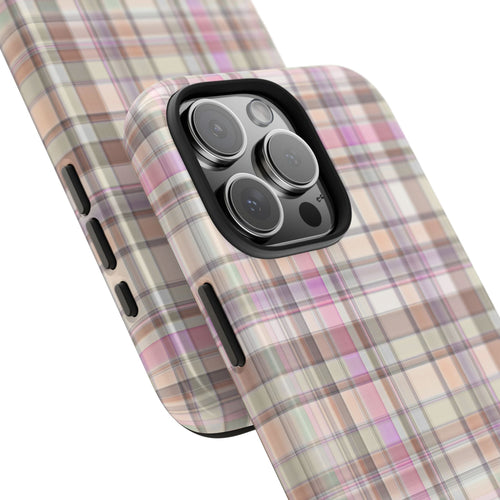 Plaid phone case angled view; pink tan white checks with raised camera lens bezel