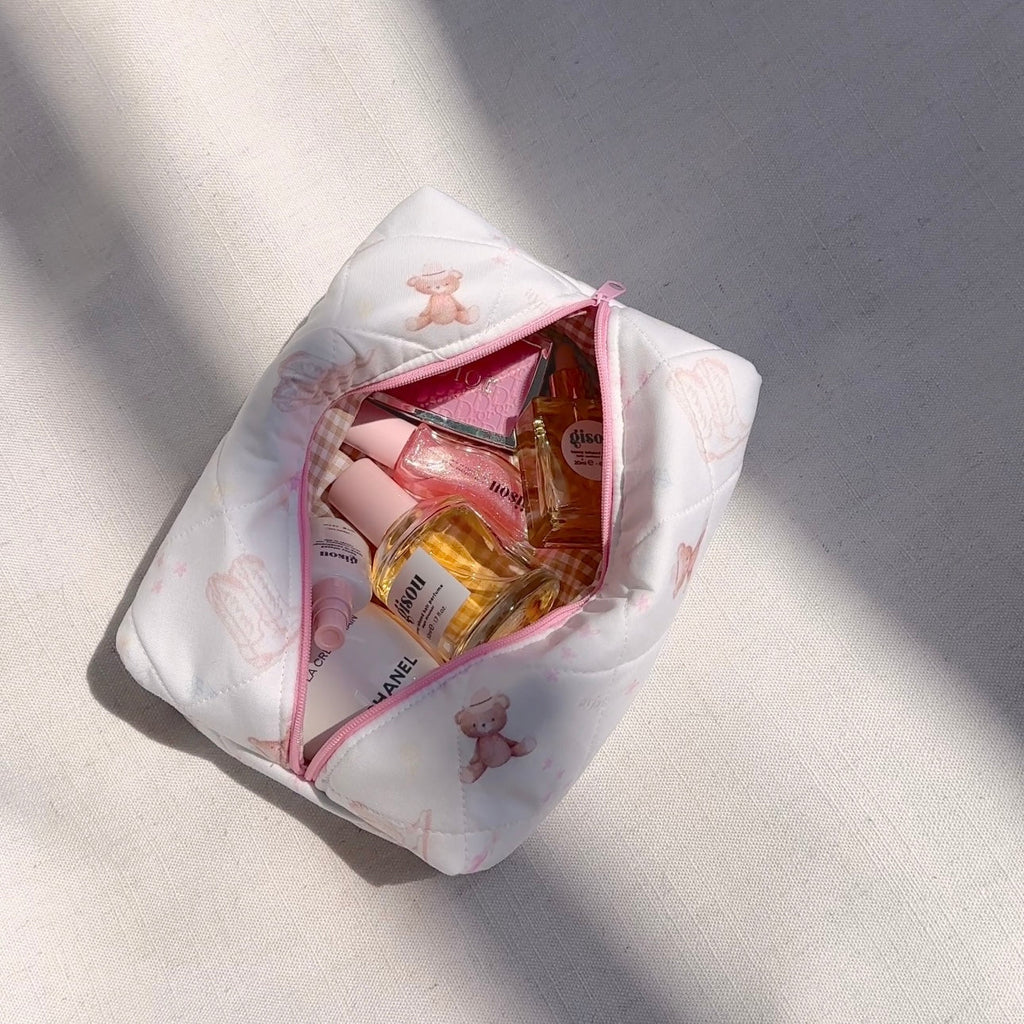 White quilted pouch open with pink zipper and teddy bear print