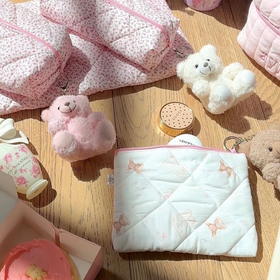 Quilted white pouch with pink zipper and teddy bear print