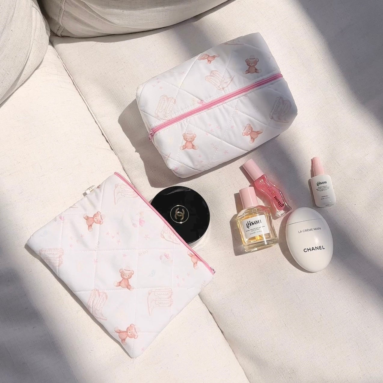 White quilted pouch set with pink zippers and teddy bear motifs