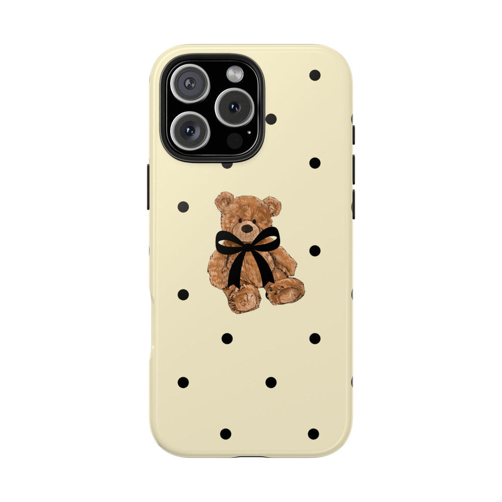 Cream case with black polka dots, teddy bear with bow centered above camera cutout