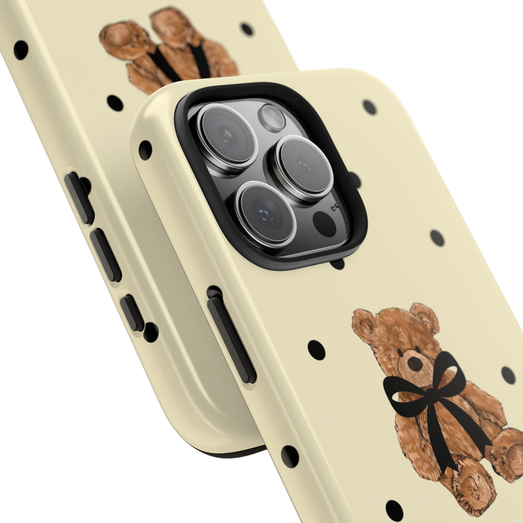 Cream teddy bear phone case with black polka dots, angled view showing side buttons