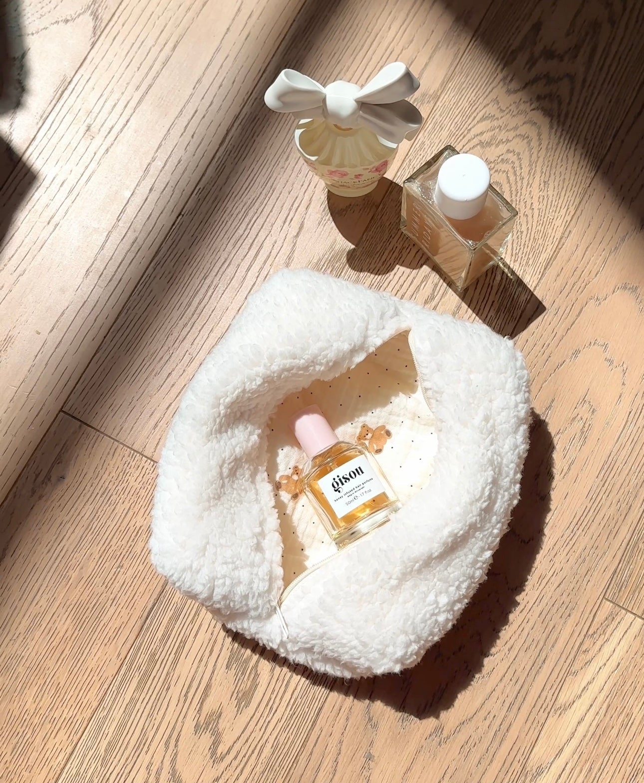 Cream plush teddy-style zipper pouch, open interior view with rounded shape