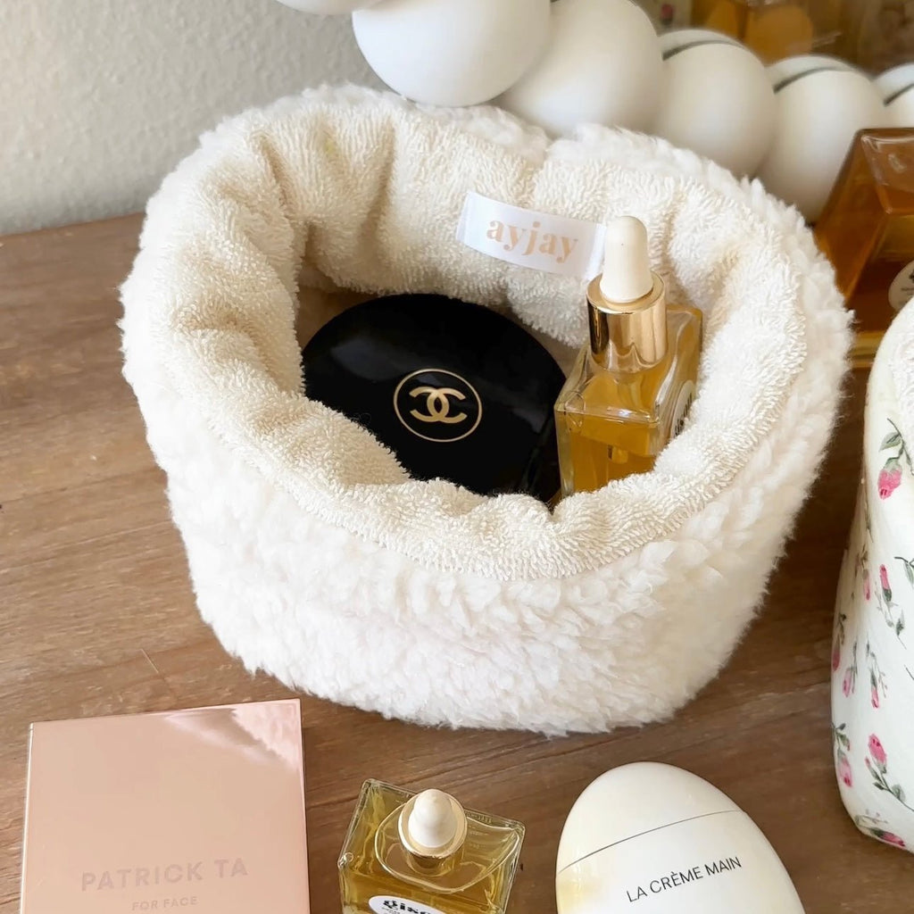 Cream soft teddy round organizer bowl with open center, holds small bottles and accessories
