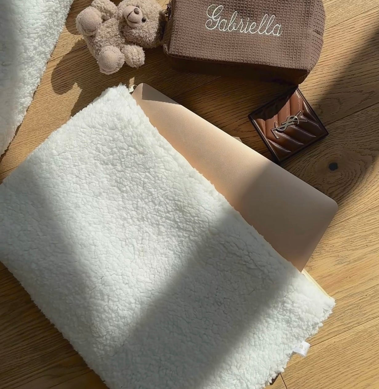 Cream teddy pouch exterior close-up with fuzzy texture and side zipper seam