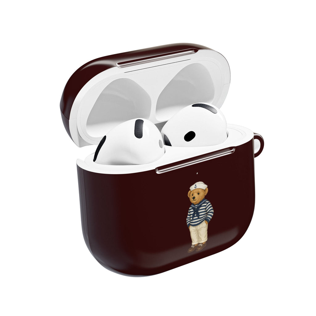 Dark burgundy AirPods case with sailor teddy bear charm, open lid