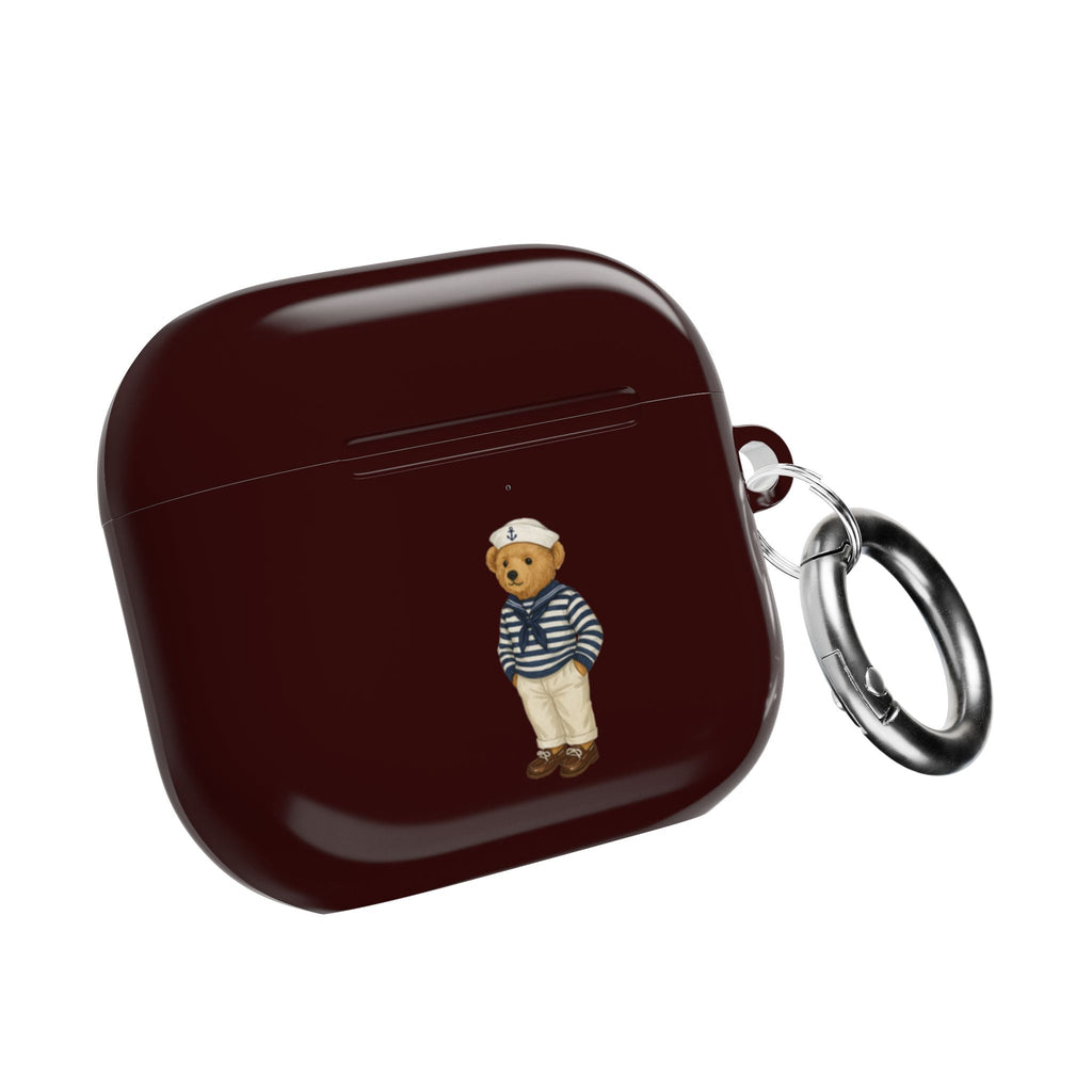 Dark burgundy AirPods case with sailor teddy bear charm and metal key ring, closed