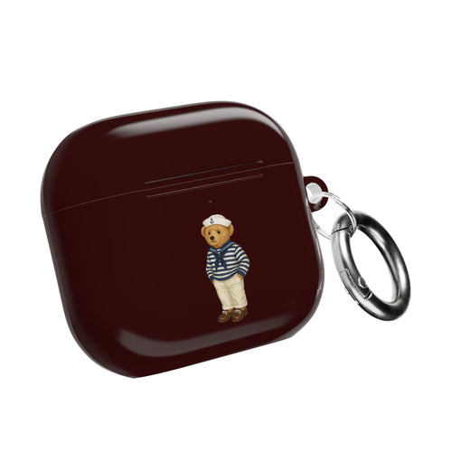 Dark burgundy AirPods case with sailor teddy bear charm and metal key ring, closed
