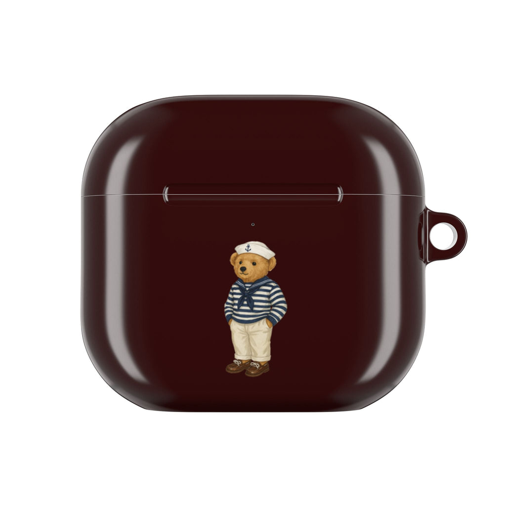 Dark burgundy AirPods case with centered sailor teddy bear charm, front view