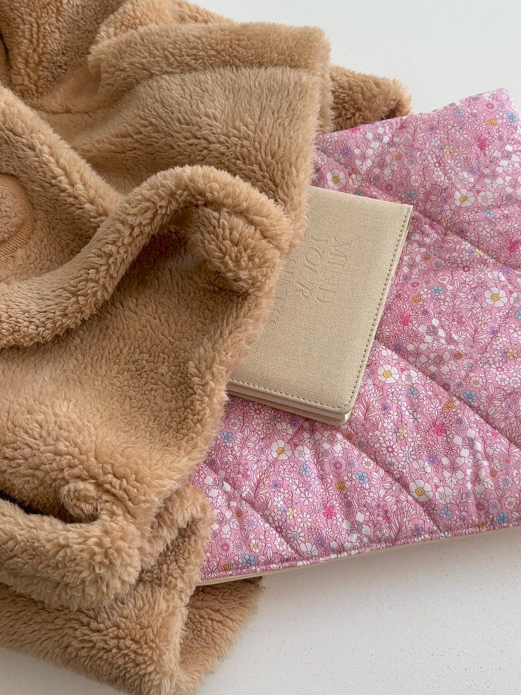 Beige sherpa jacket with dark pink floral lining and beige front panel detail